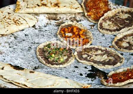 https://l450v.alamy.com/450v/bhfxe6/taco-shells-with-a-variety-of-delicious-toppings-cooked-over-a-charcoal-bhfxe6.jpg