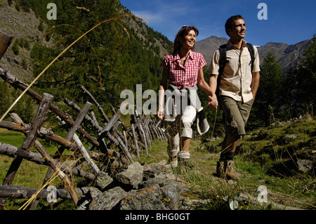 A mid adults couple hiking in the mountains in summer, Val Venosta, Vinschgau, South Tyrol, Italy, Europe Stock Photo
