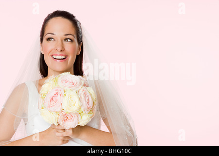 Smiling bride holding a bouquet