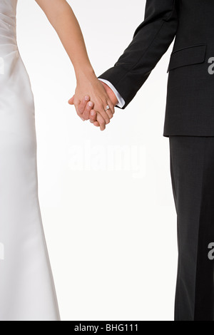 Bride and groom holding hands Stock Photo