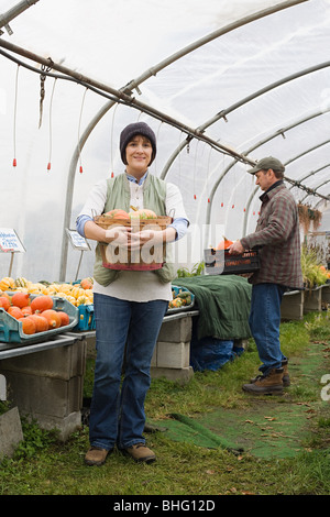 Farmers in greenhouse with pumpkins Stock Photo