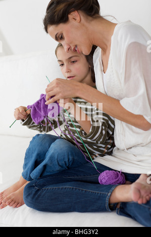 little girl shown how to knit Stock Photo