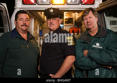 Policeman and emergency medical technicians Stock Photo