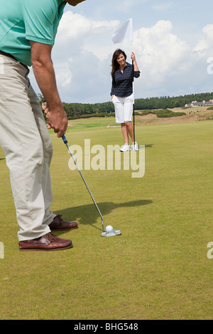 Couple playing golf Stock Photo