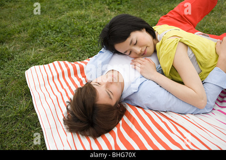 Young couple lying on blanket Stock Photo