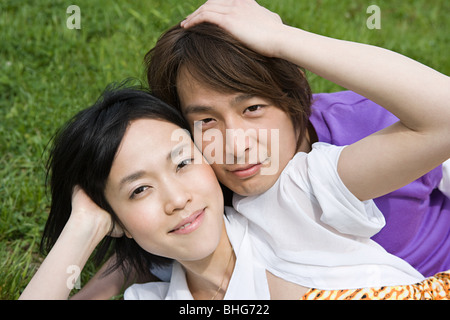 Young couple lying on grass Stock Photo