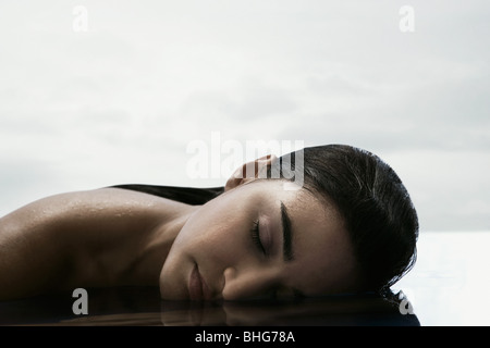 Young woman with face in water Stock Photo