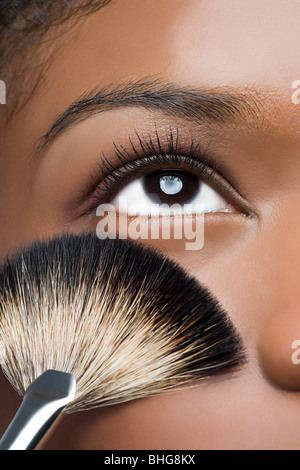 Woman with makeup brush near eye Stock Photo