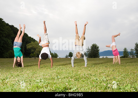 Teenagers doing handstands Stock Photo