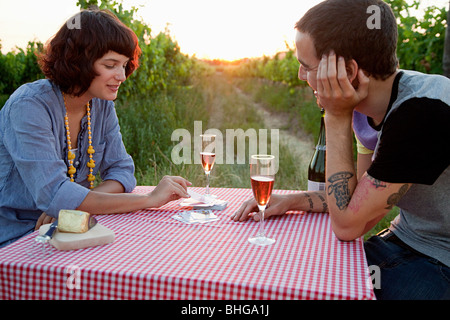 Couple playing cards on table in field Stock Photo