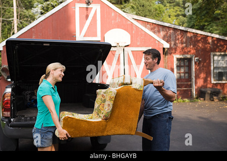Couple moving armchair Stock Photo