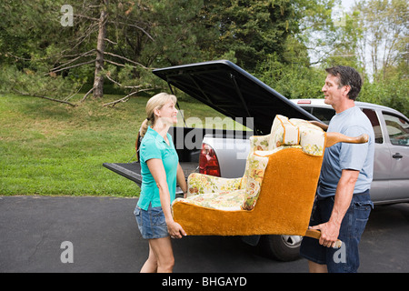 Couple moving armchair Stock Photo