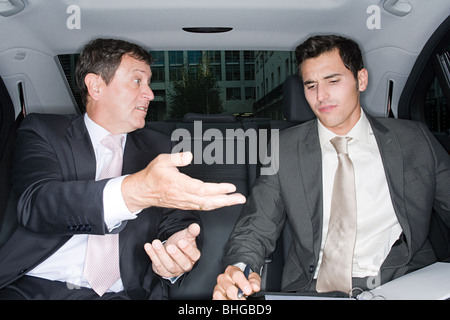 Businessmen talking in car Stock Photo