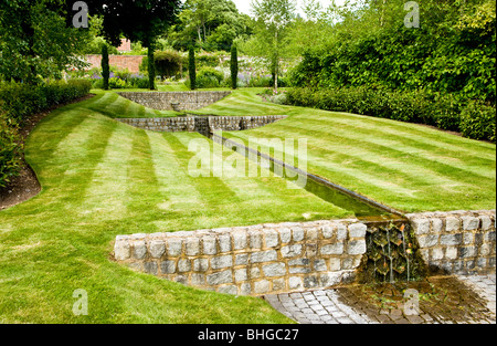 A water feature or rill in an English country garden on a summer's day. Stock Photo