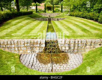 A water feature or rill in an English country garden on a summer's day. Stock Photo