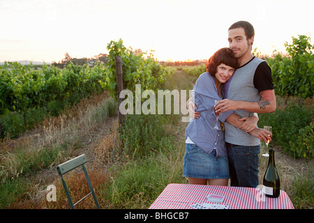 Couple in a field with table and wine Stock Photo