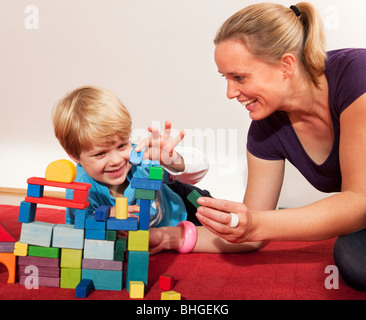 mother and son play with building blocks Stock Photo