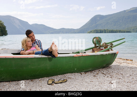 A young couple daydreaming in a boat Stock Photo