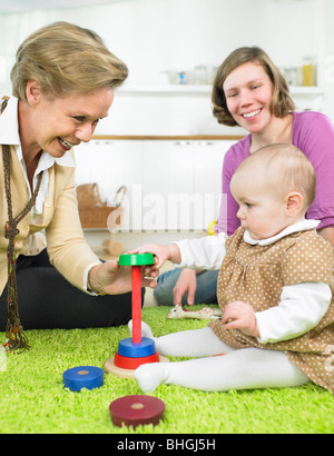 Women and baby playing together Stock Photo