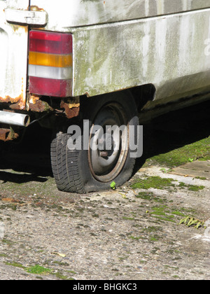 old van with flat tyre wheel Stock Photo