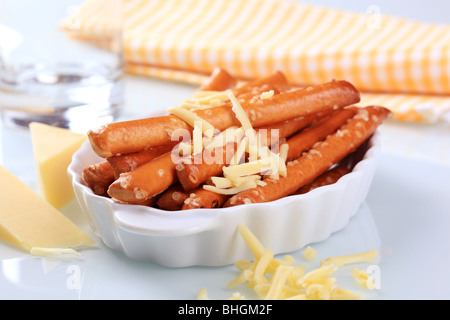Savory snack - Crispy bread sticks and grated cheese Stock Photo