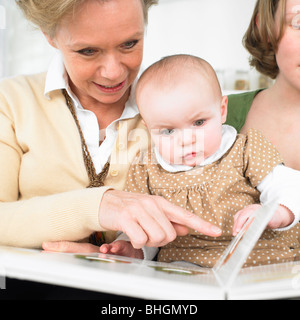 grandmother and baby reading book Stock Photo