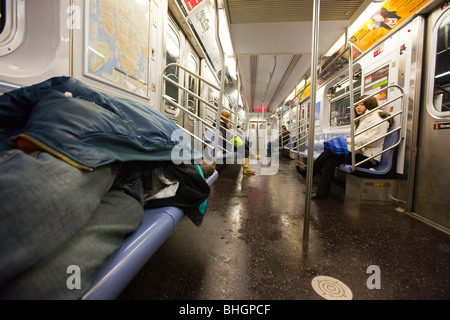 Homeless man sleeping on the subway in New York City Stock Photo - Alamy