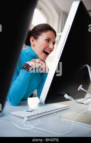 woman sitting at terminal typing Stock Photo