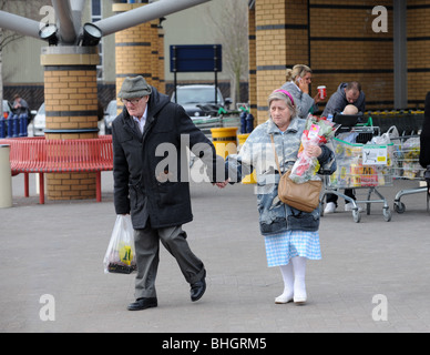 Elderly couple holding hands while shopping together Stock Photo
