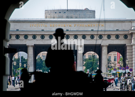 A Viennese Fiaker horse carriage drives through the gates at Hofburg Palace in Vienna Austria Stock Photo