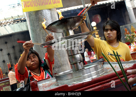 People using lamp oil in Chinese Temple , Bangkok's Chinatown , Chinese new year 2010 Stock Photo