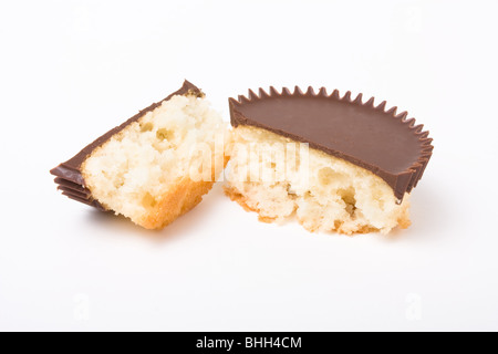 Chocolate topped sponge cup cake isolated against white background. Stock Photo