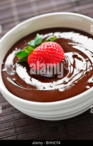 Fresh strawberry dipped in melted chocolate in bowl Stock Photo