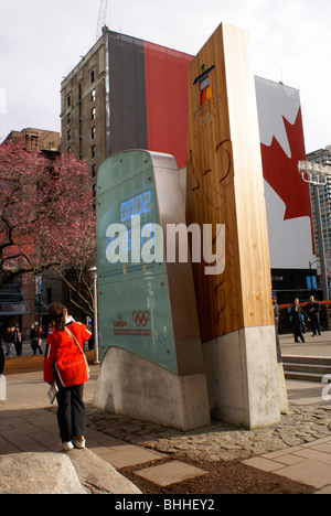 Girl looking at the official Olympic clock for the 2010 Winter Games, Vancouver, British Columbia, Canada. Stock Photo