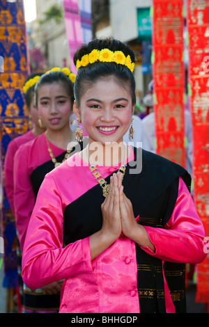 Wai buddhist greeting, respect, culture Thai cultural female asian woman dancer, portrait, traditional, flower art, clasped hand gesture Thailand. Stock Photo