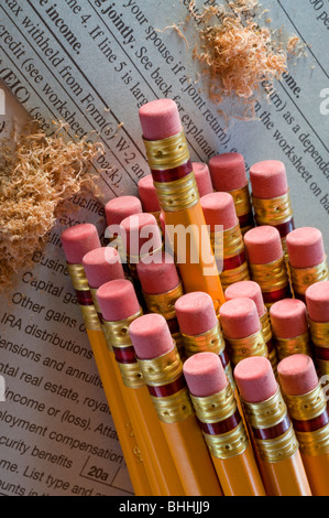 Groups of pencil erasers tops sitting on tax forms Stock Photo