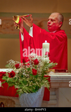 A Hispanic priest celebrates Mass at a Long Beach, California, Catholic church. Stock Photo