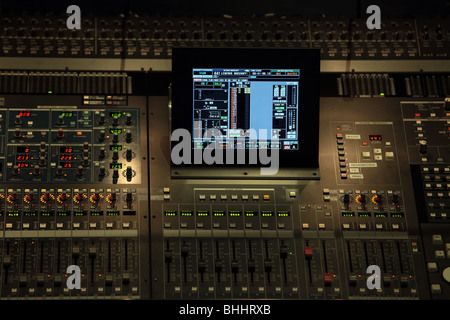 Digital control panel in dark for audio and lighting of stage production. Buttons, levers and electronics. LCD display. Stock Photo