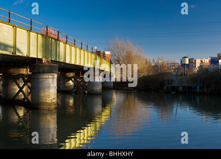 Green railway bridge over the RIver Nene in central Peterborough, Cambridgeshire Stock Photo