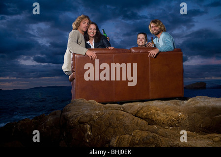 group on couch outside night fun Stock Photo