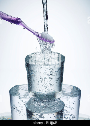 Toothbrush under running water Stock Photo