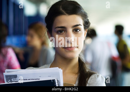 Female high school student holding books, portrait Stock Photo