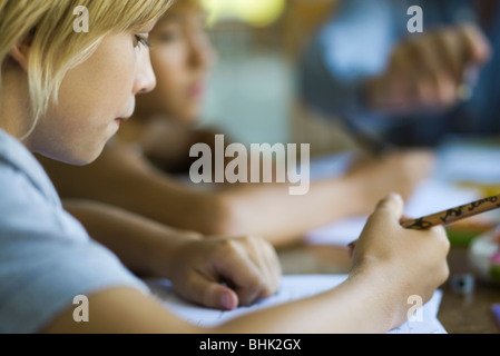 Student writing classwork assignment Stock Photo