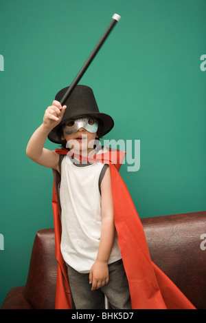 Boy in costume pretending to be magician Stock Photo
