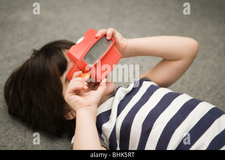 Child looking through toy viewfinder Stock Photo
