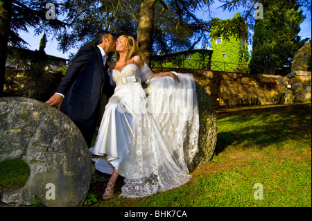 Newlyweds kissing at sunset in a park Stock Photo