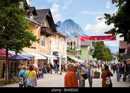 Garmisch Partenkirchen street scene - shops in the town centre, Germany, Bavaria with Zugspitze mountain in background Stock Photo