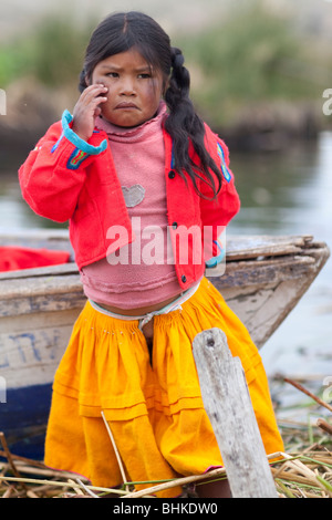 A young Uros child, part of the community who live on floating reed islands on Lake Titicaca Stock Photo