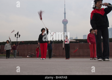 People exercising along the Huang Pu riverfront overlooking the Pudong in Shanghai, China, Asia Stock Photo