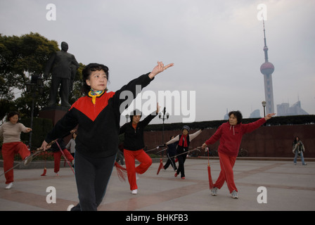 People exercising along the Huang Pu riverfront overlooking the Pudong in Shanghai, China, Asia Stock Photo